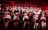 orkiestra, muzycy przebrani w białe stroje, czapeczki i z przyczepionymi czerwonymi nosami