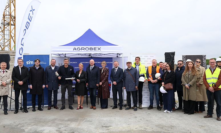 Kilkanaście osób pozuje do zdjęcia, to uczestnicy uroczystości wmurowania aktu erekcyjnego pod budowę nowych mieszkań